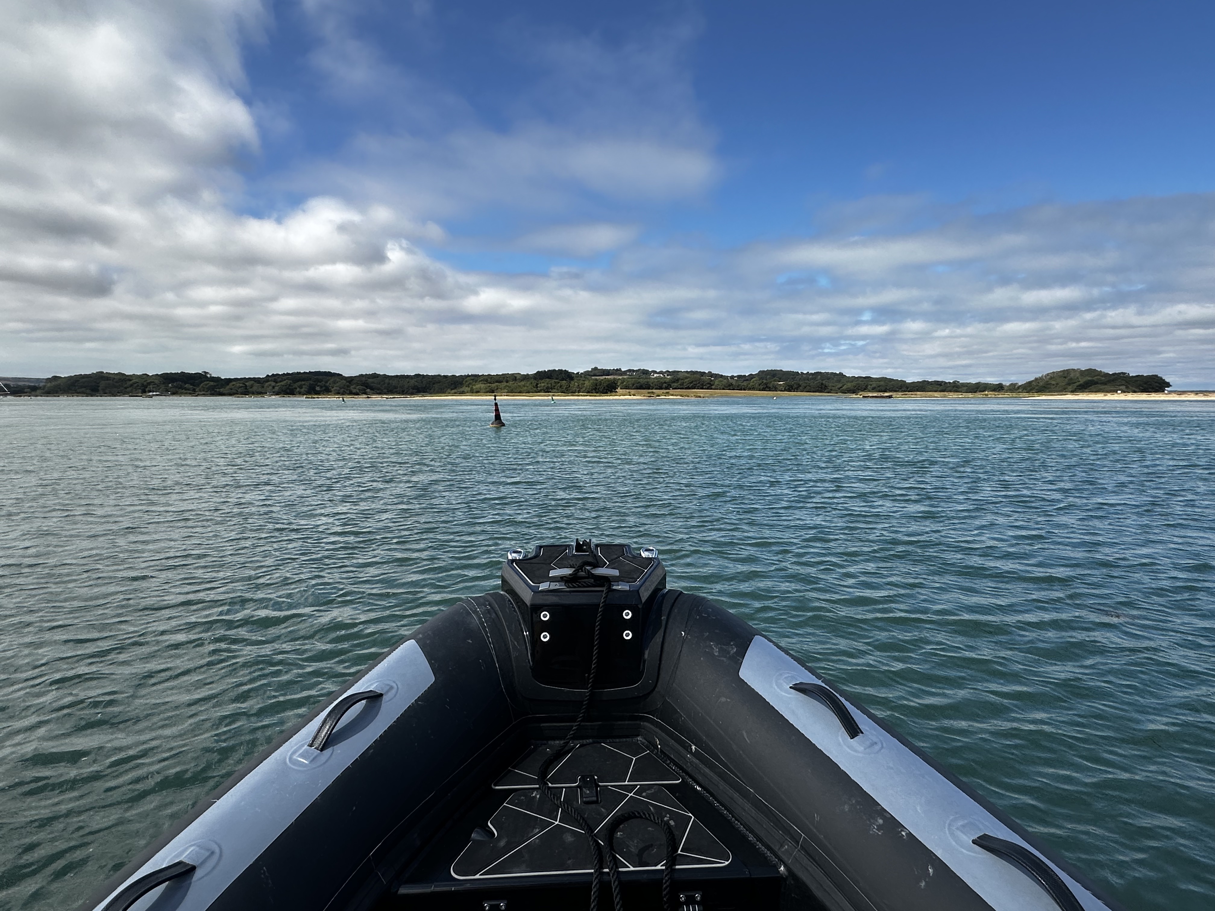 A cardinal mark in the distance seen over the bow of a RIB